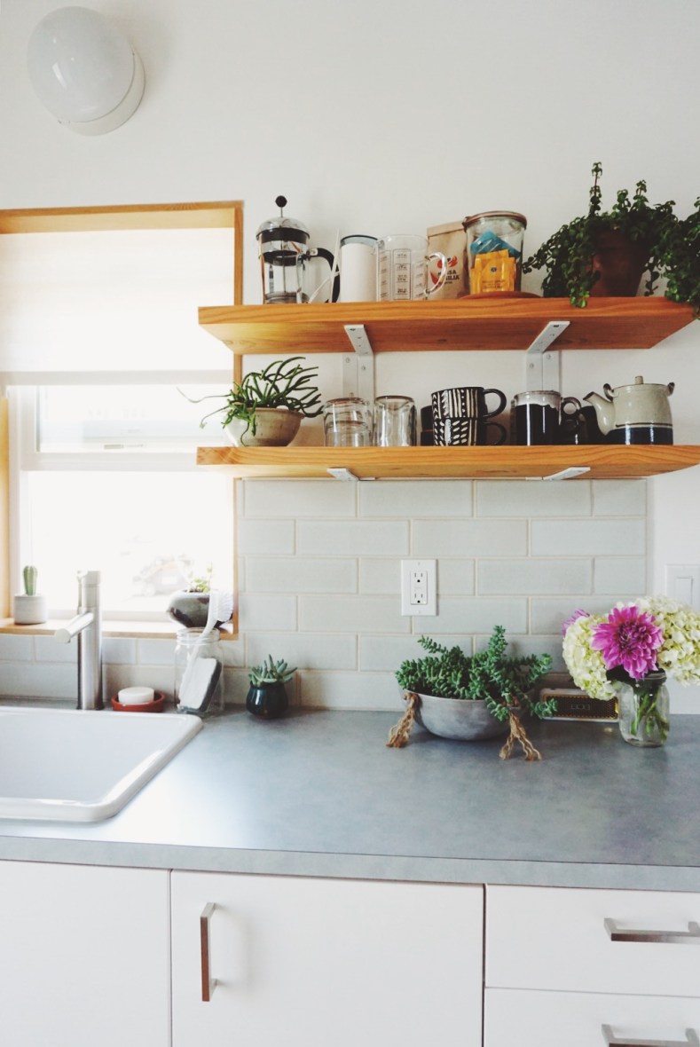 bright scandinavian designed kitchen with floating shelves